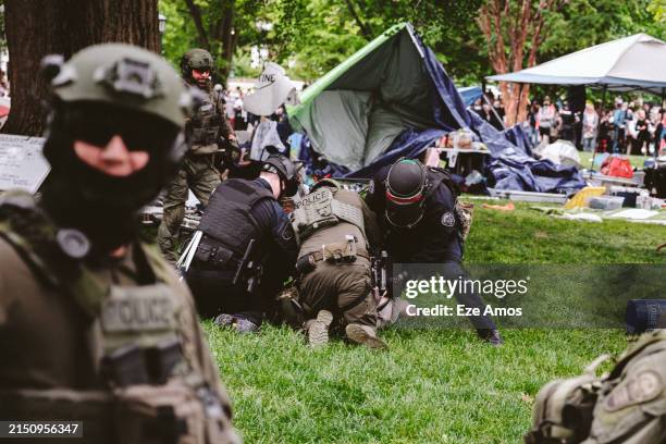 Heavily armed policemen arrests a protester on university grounds after the police declared an unlawful gathering to disperse protesters encampment...