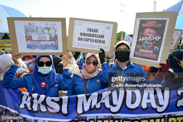 Indonesian workers march down the street during May Day rally on May 01, 2024 in Surabaya, Indonesia. People across Indonesia have organize rallies...