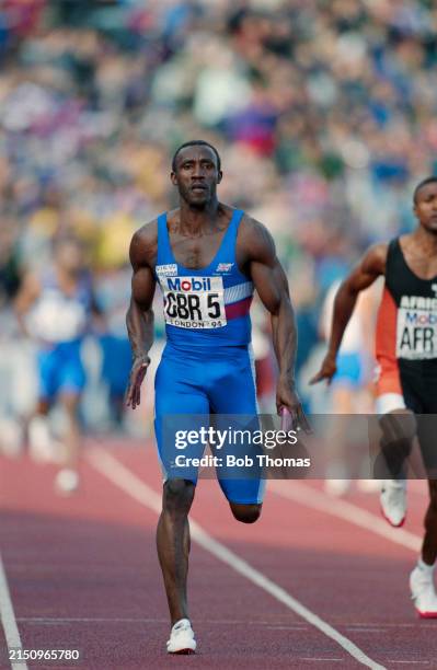 British athlete Linford Christie competes for Great Britain on the final leg to finish in first place in the 4 x 100 metres relay event during the...