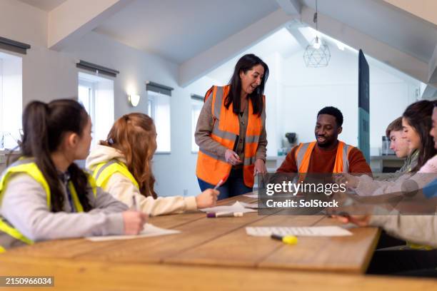 volunteers learning about safety - workplace safety stock pictures, royalty-free photos & images