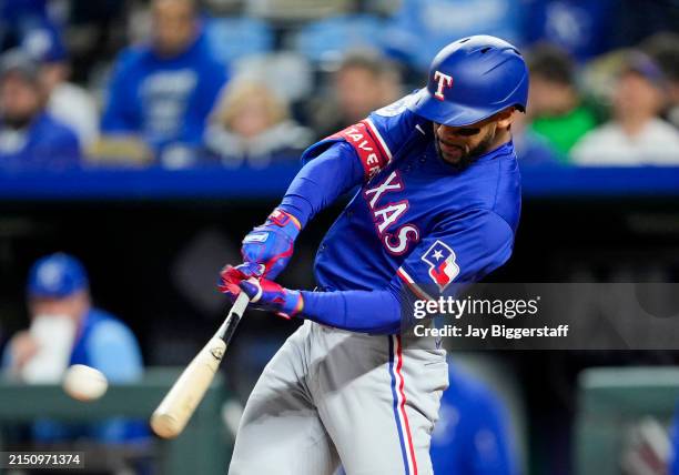 Leody Taveras of the Texas Rangers hits an RBI double during the eighth inning against the Kansas City Royals at Kauffman Stadium on May 4, 2024 in...