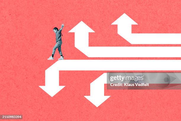 girl balancing on white arrow signs - alternativ bildbanksfoton och bilder
