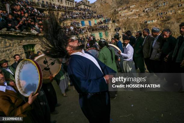 Huge crowd watch on as people sing, dance and play the daf drums during a feast in honour of the marriage, probably mythical, of Pir Shalyar , a...