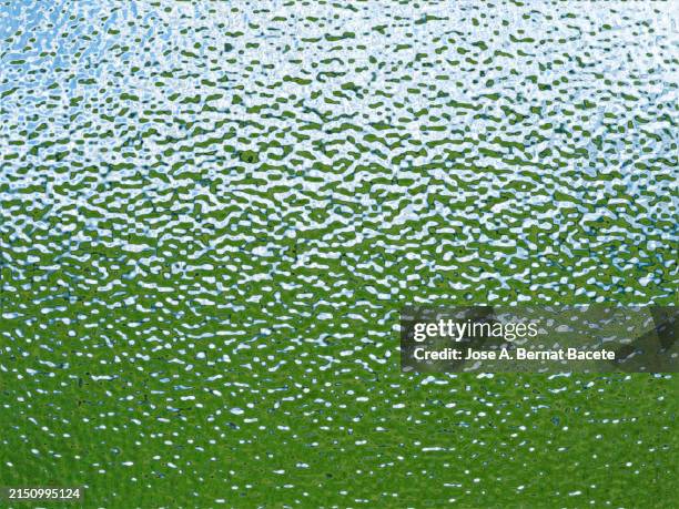 close up of corrugated plastic sheet on a green background. - corrugated stock pictures, royalty-free photos & images