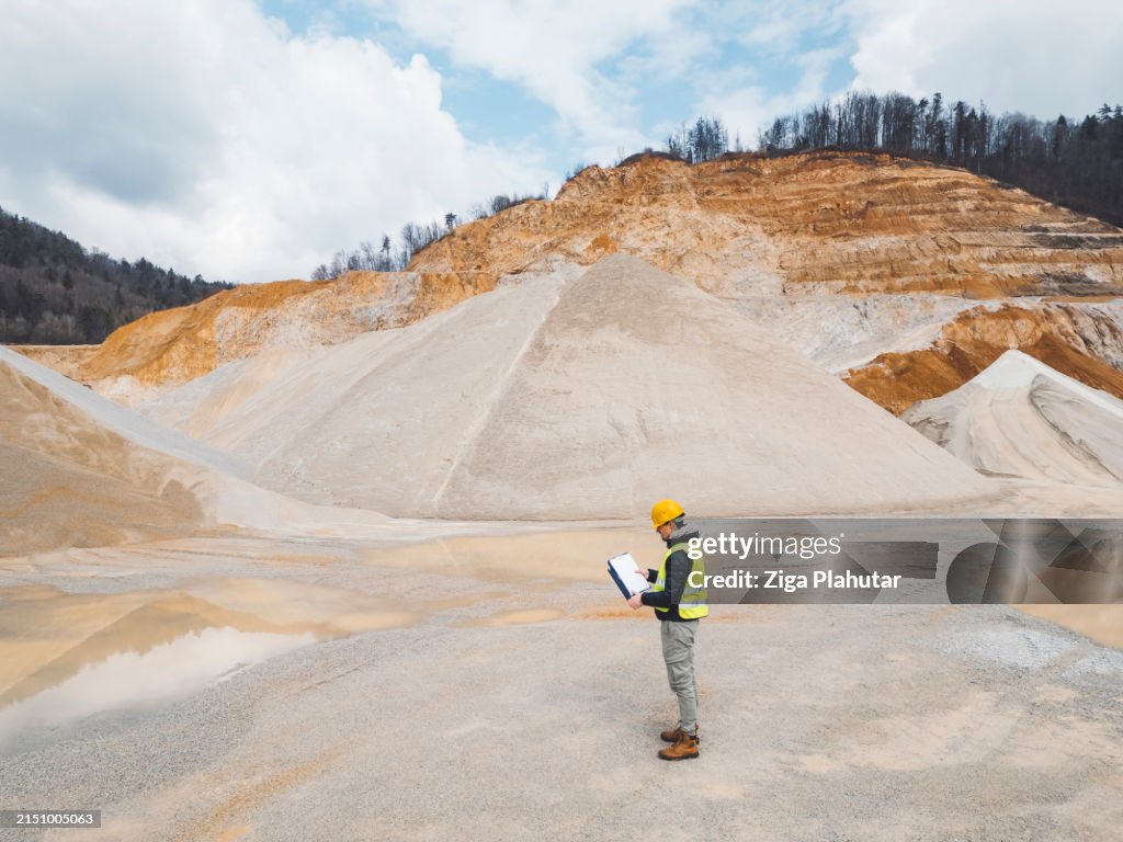 Inspector standing on quarry grounds, checking out the site
