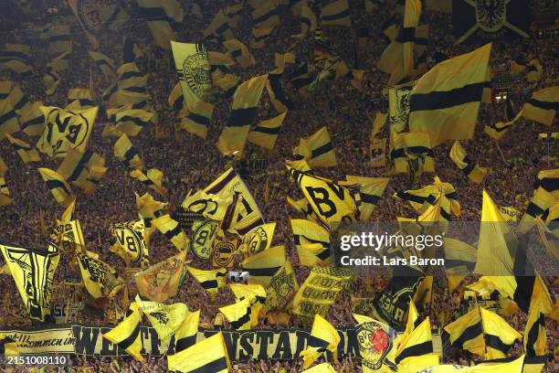 Fans of Borussia Dortmund show their support as they wave flags in the Yellow Wall, seen prior to the UEFA Champions League semi-final first leg...