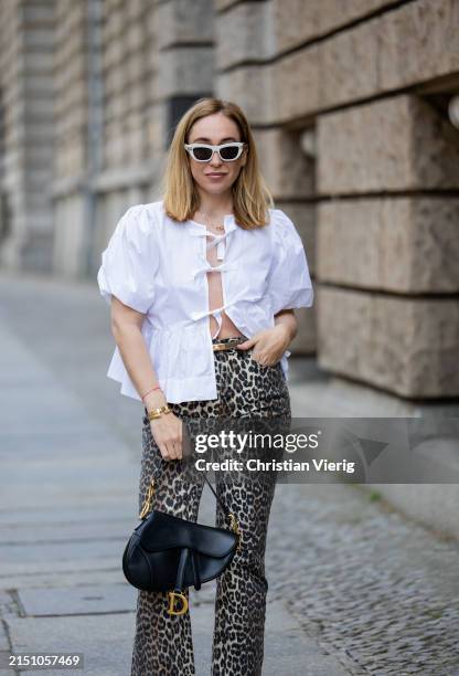Sonia Lyson is seen wearing Ballerinas Zara, leopard print pants & white blouse Ganni, bag & sunglasses Dior, belt Hermes on May 01, 2024 in Berlin,...