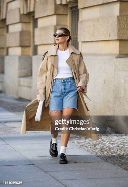 Sophia Geiss is seen wearing denim shorts Levi’s , beige trenchcoat Cos, loafers LeGer by Lena Gercke, white socks, white bag Coperni, Tshirt Uniqlo,...