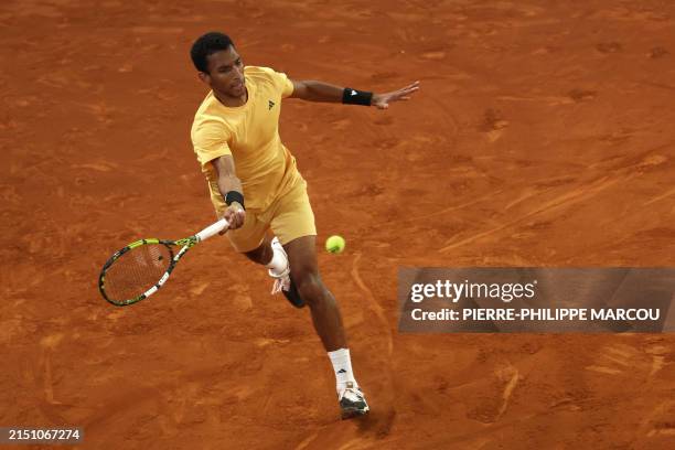Canada's Felix Auger-Aliassime returns the ball to Russia's Andrey Rublev during the 2024 ATP Tour Madrid Open tournament singles final tennis match...