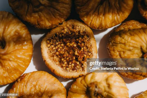 dried figs on white surface - fig stock pictures, royalty-free photos & images
