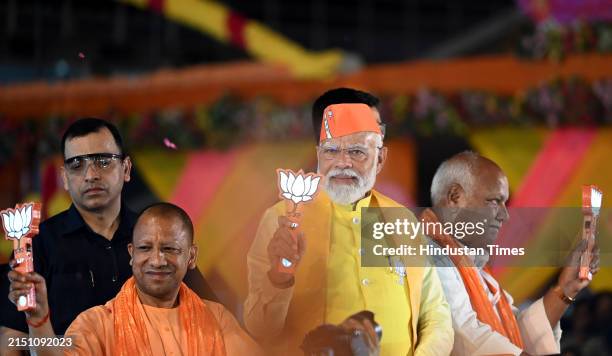 Prime Minister Narendra Modi during the road show in Ayodhya in a support of BJP candidate Lallu Singh from Faizabad parliamentary seat, UP CM Yogi...