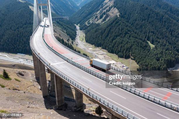 truck driving on cable-stayed bridge - elevated road stock pictures, royalty-free photos & images