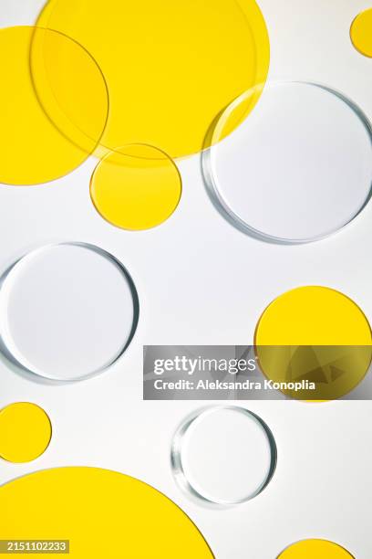 abstract 3d background composition made of translucent yellow and clear glass geometric shapes lying on white backdrop. - translucent stock pictures, royalty-free photos & images