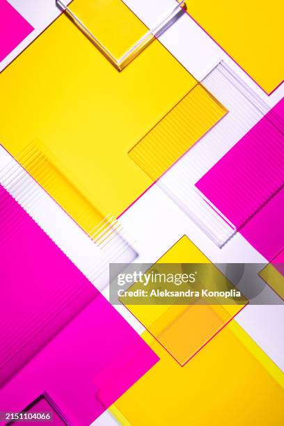 abstract 3d geometric flat lay background design - minimalist pattern made of translucent neon magenta pink, yellow and clear glass geometric shapes on white backdrop. - translucent glass stock pictures, royalty-free photos & images