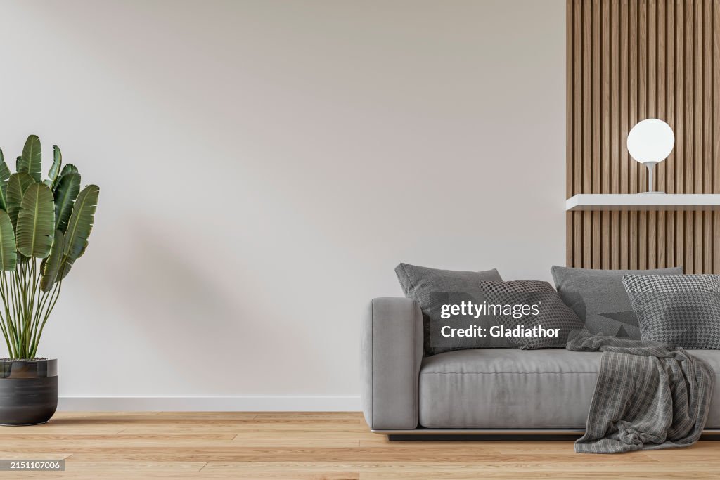 Modernes Interieur: ein Wohnzimmer mit einem grauen Sofa, weißem und hartholzgetäfeltem Wandhintergrund und Dekoration