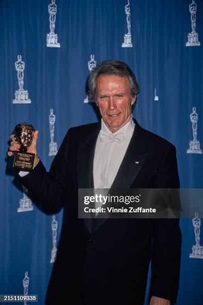 American actor and film director Clint Eastwood, wearing a tuxedo and white bow tie, with his Irving G Thalberg Memorial Award in the 67th Academy...