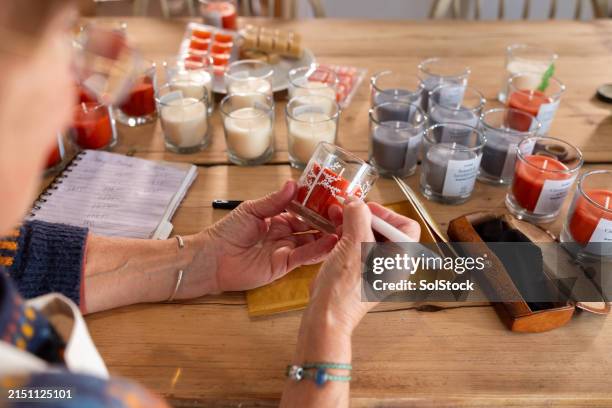 decorating one candle at a time - candle making stock pictures, royalty-free photos & images