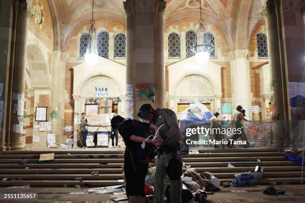California Highway Patrol officer detains a protestor while clearing a pro-Palestinian encampment after dispersal orders were given at the University...