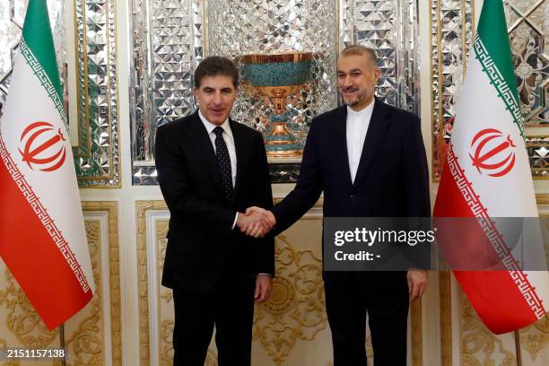Iran's Foreign Minister Hossein Amir-Abdollahian greets Nechirvan Barzani, the regional president of Iraqi Kurdistan, during an official visit to...