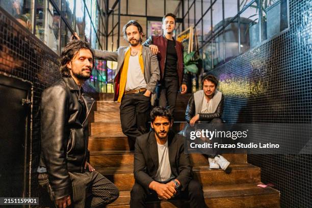 porträt einer rockband auf der treppe einer kneipe - boygroup stock-fotos und bilder