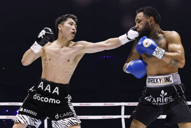 Japan's Naoya Inoue throws a punch at Mexico's Luis Nery in the third round of their four-belt super bantamweight boxing title match at Tokyo Dome on...