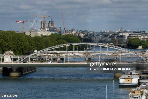 This photograph taken on May 6 shows Viaduc d'Austerlitz and Pont Charles-de-Gaulle bridges over the river Seine and Notre-Dame de Paris Cathedral on...