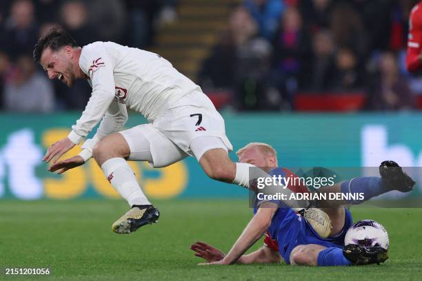 Manchester United's English midfielder Mason Mount is tackled by Crystal Palace's English midfielder Will Hughes during the English Premier League...