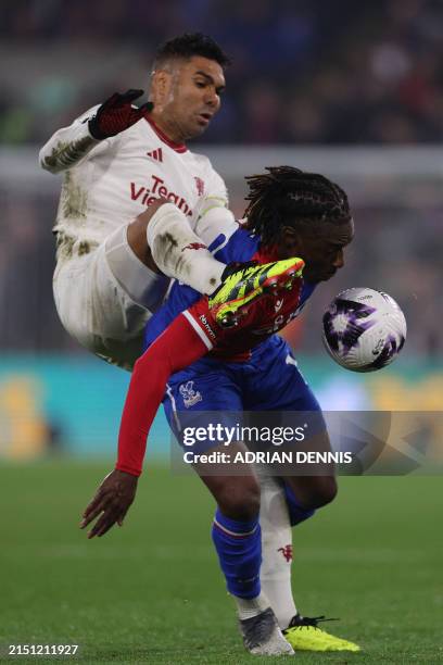 Manchester United's Brazilian midfielder Casemiro vies with Crystal Palace's English midfielder Eberechi Eze during the English Premier League...