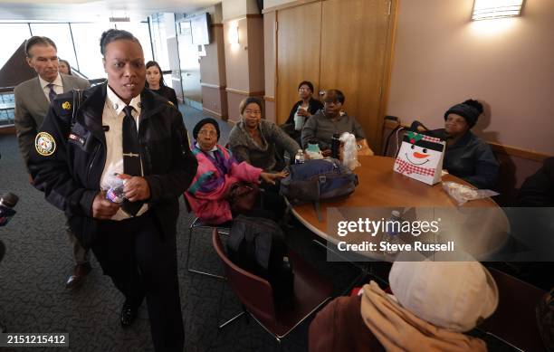 Toronto Police Superintendent Stacy Clarke walks past a foyer full of supporters who bused in for the haring. Toronto Police Superintendent Stacy...
