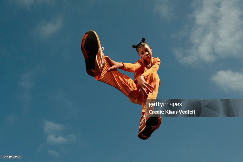 Full length of teenage girl levitating high up