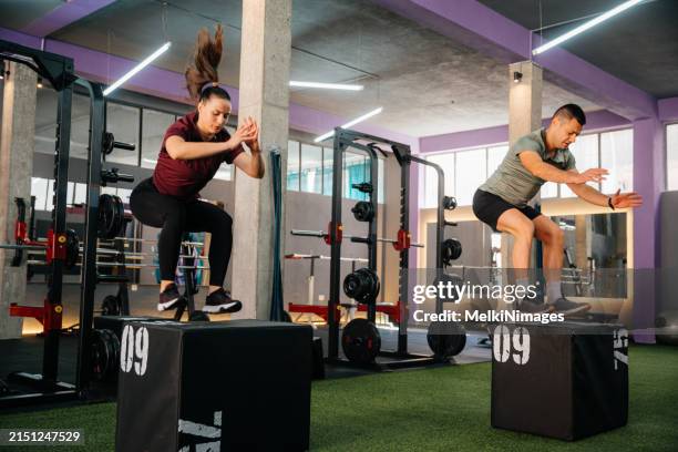 people doing fitness group box jumping at the gym - crossfit box jump imagens e fotografias de stock