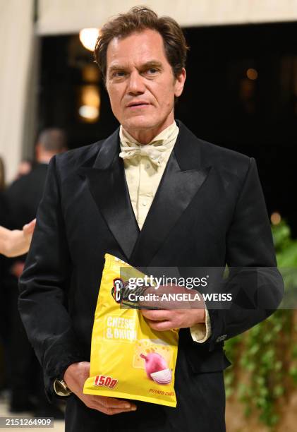 Actor Michael Shannon holds a bag meant to look like potato chips as he arrives for the 2024 Met Gala at the Metropolitan Museum of Art on May 6 in...