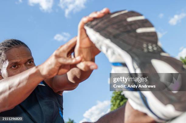 sportsman stretching - hamstring stretch stock pictures, royalty-free photos & images