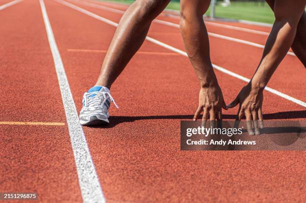runner stretching on running track - track event stock pictures, royalty-free photos & images