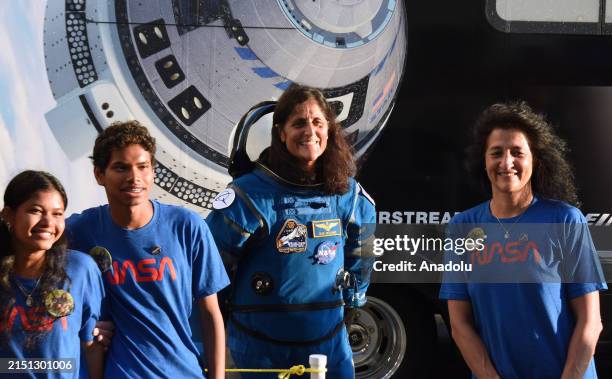 Astronaut Suni Williams poses with friends and family after she and NASA astronaut Butch Wilmore walk out of the Neil Armstrong Operations and...
