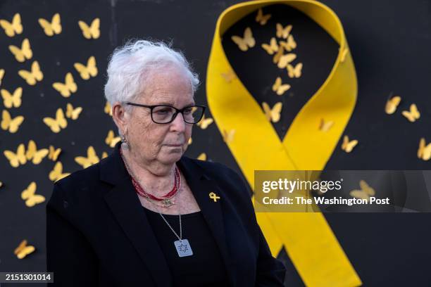 Holocaust survivor Hannah Gofrit stands next to an installation of a giant yellow ribbon with butterflies on the eve of the country's Holocaust...