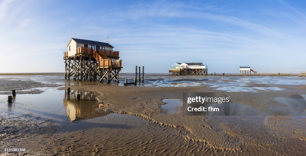 Travel destination: Stilt houses on the beach in St. Peter Ording (Schleswig-Holstein, Germany)