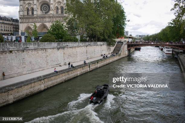 Boat of the river brigade of the police guards the area on the Seine river nearby the Notre Dame Cathedral in Paris, France on May 3, 2024. The...