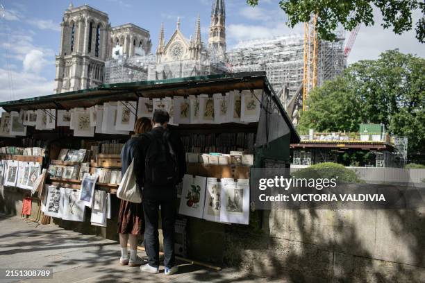 Bouquiniste stand with the view of the Notre Dame Cathedral in Paris, France on May 3, 2024. The reconstruction, which aims to be ready before the...