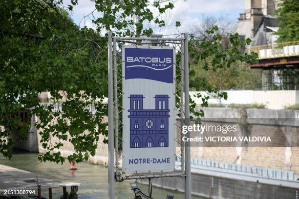 Batobus sign on the side the Notre Dame Cathedral in Paris, France on May 3, 2024. The reconstruction, which aims to be ready before the Olympic...