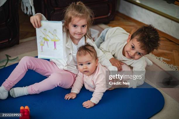 a small group of children are playing in the living room - tiny boy stock pictures, royalty-free photos & images
