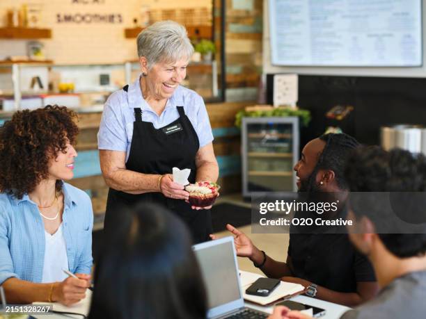team business meeting in a small cafe - waitress stock pictures, royalty-free photos & images