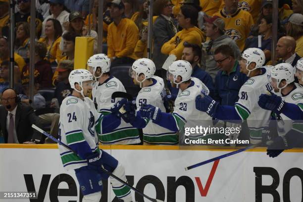 Pius Suter of the Vancouver Canucks celebrates with his teammates after scoring a goal against the Nashville Predators during the third period in...