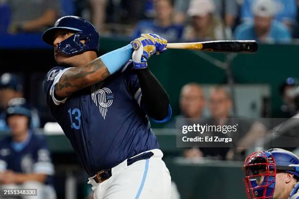 Salvador Perez of the Kansas City Royals hits a three-run home run in the seventh inning against the Texas Rangers at Kauffman Stadium on May 03,...