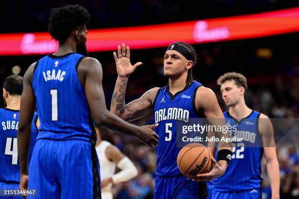 Paolo Banchero of the Orlando Magic high-fives teammate Jonathan Isaac after a play against the Cleveland Cavaliers during the fourth quarter in Game...