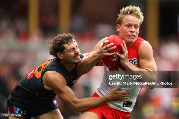 Isaac Heeney of the Swans is tackled by Harry Perryman of the Giants during the round eight AFL match between Sydney Swans and Greater Western Sydney...