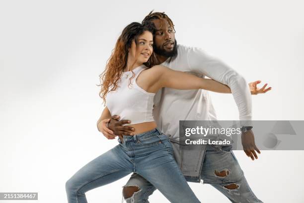 urban mixed race couple dancing in studio - bachata stock pictures, royalty-free photos & images