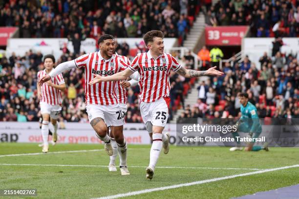 Luke Cundle of Stoke City celebrates scoring his team's first goal with team mate Josh Laurent during the Sky Bet Championship match between Stoke...