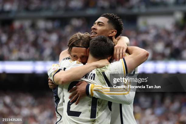 Jude Bellingham of Real Madrid celebrates scoring his team's second goal with teammates Brahim Diaz and Luka Modric during the LaLiga EA Sports match...