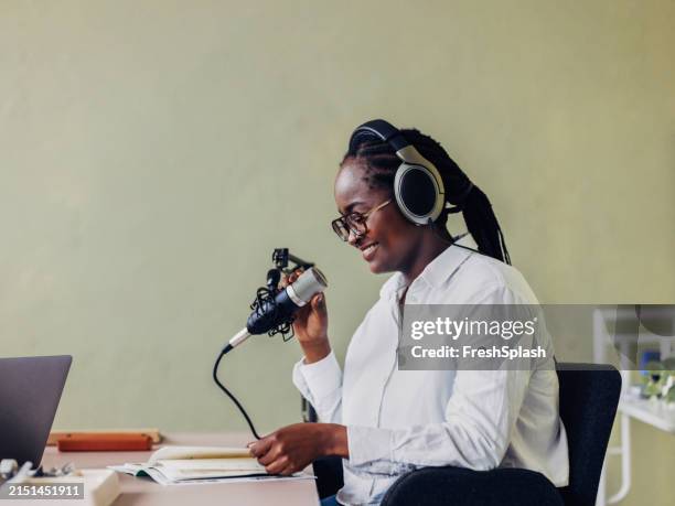 mujer profesional grabando podcast en el estudio - presentador de televisión fotografías e imágenes de stock